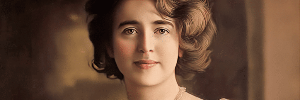 Portrait of a young woman with short wavy hair and a pearl necklace, in a vintage studio setting